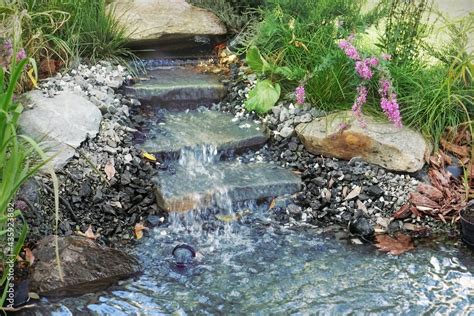 Small Waterfall And Cascade Stream Of Water In A Home Private Garden