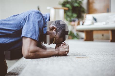 A Man Kneeling In Prayer At An Altar — Photo — Lightstock