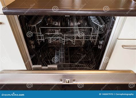 Modern Half Open Empty Dishwasher In A Modern Kitchen Stock Photo