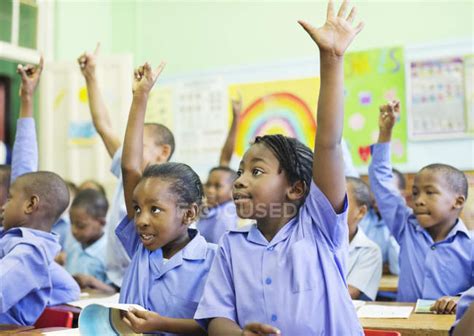 African American Students Raising Hands In Class — Looking Away