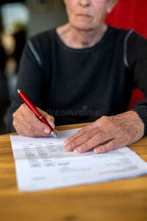 Close Up Of Older Womans Hand Signing A Paper Stock Photo Image Of