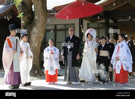 Shinto Wedding Procession With Bride Wearing The Traditional Watabōshi