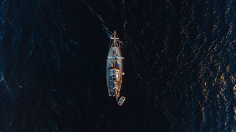 A Drone Shot Of A Boat In The Ocean Lost At Sea 4k Hd Wallpaper