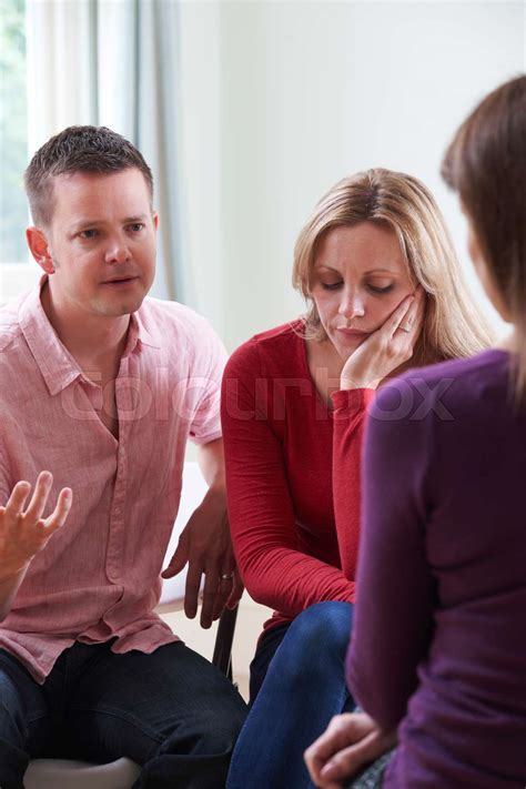 Couple Discussing Problems With Relationship Counsellor Stock Image