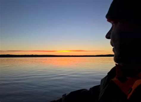 Fisherman Admiring The Midnight Sun At The Arctic Circle