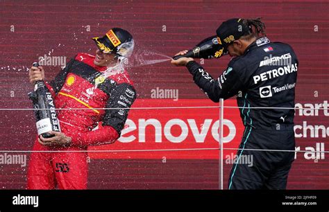 Race Winner Carlos Sainz Of Ferrari Left With Mercedes Lewis Hamilton On The Podium After The