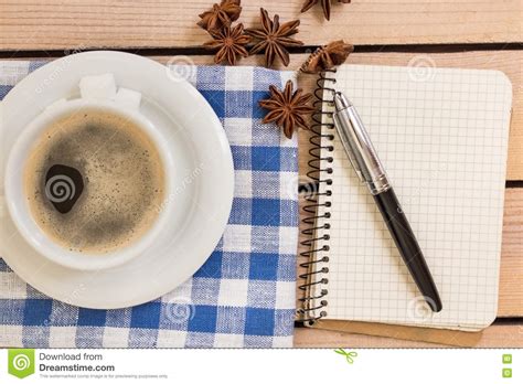 Cup Of Coffee And Notepad With Pen On Wooden Background Stock Photo