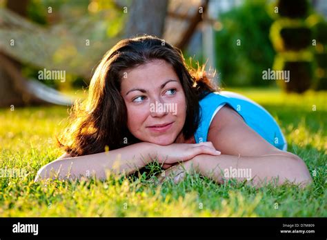 Brunette Girl Lying On The Grass Stock Photo Alamy