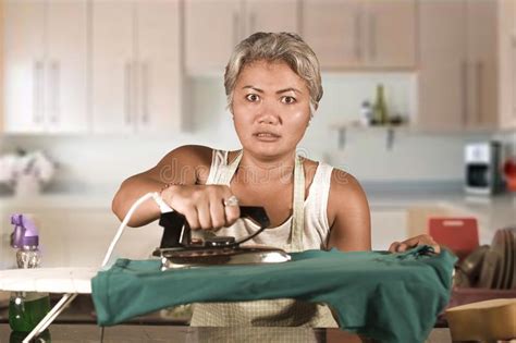 Attractive Upset And Stressed Woman 40s To 50s Ironing Tired And Unhappy At Home Kitchen Doing