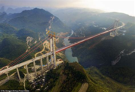 Chinese Engineers Put Finishing Touches To Huge Suspension Bridge In
