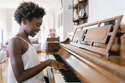 Young Black Girl Playing Piano By Stocksy Contributor Raymond Forbes