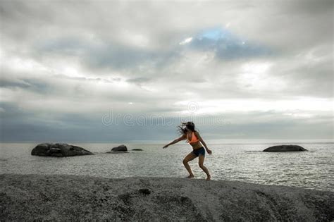 Woman Jumping On A Rock At Sunset On Bakovern Beach Cape Town Stock Image Image Of Marine