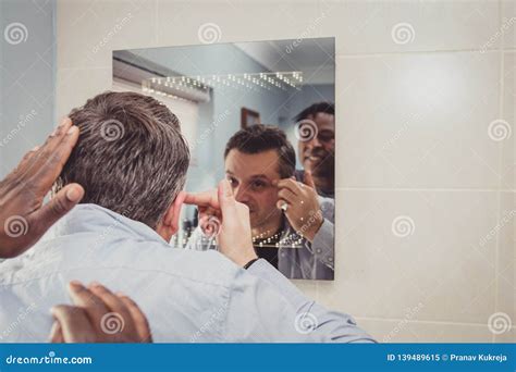 A Gay Couple Together In Front Of The Bathroom Mirror Stock Image Image Of Mirror Admiring
