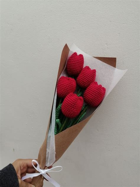 A Person Holding A Bouquet Of Red Crocheted Strawberries