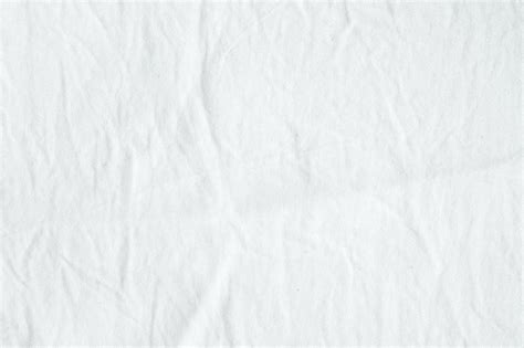 Wrinkled White Cotton Fabric Texture Background Wallpaper Premium Photo