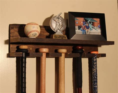 A Baseball Bat Ball And Glove Are On A Wooden Shelf In The Corner Of A