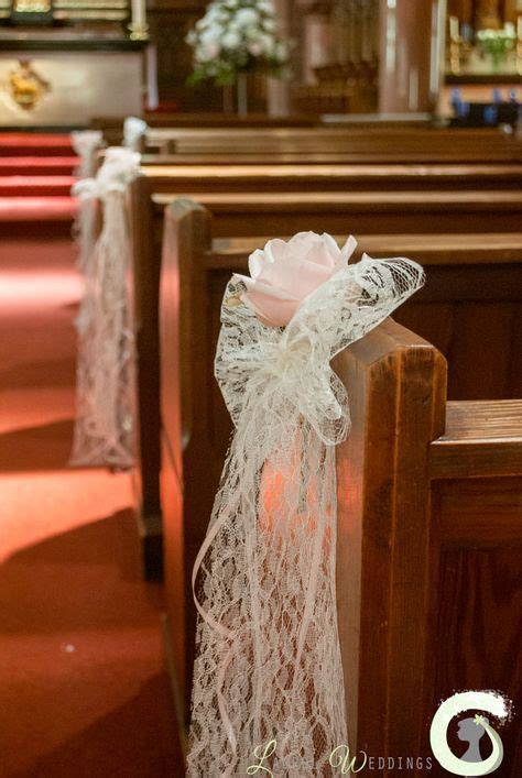 The Wedding Aisle Is Decorated With White Lace And Pink Rose Petals