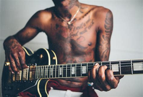 Young Tattooed Black Man Modelling With Guitar By Stocksy Contributor