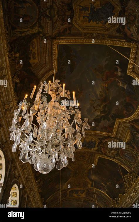 A Vertical Shot Of The Ceiling Chandelier In The Hall Of Mirrors