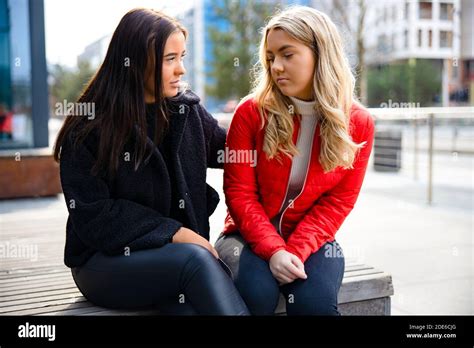 Caring Woman Comforting Her Upset And Sad Friend Outdoor Stock Photo