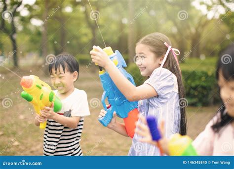 Children Playing With Water Guns On Summer Stock Photo Image Of Park