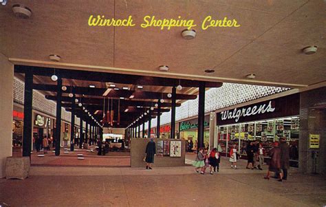 An Old Photo Of People Walking In And Out Of A Shopping Center With The