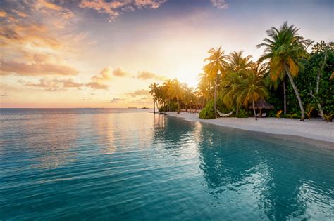 Sunrise Behind A Tropical Island In The Maldives Stock Photo Download