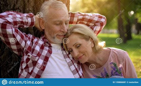 Old Couple Sitting In Park Near Tree Woman Lying On Mans Shoulder Dating Stock Image Image