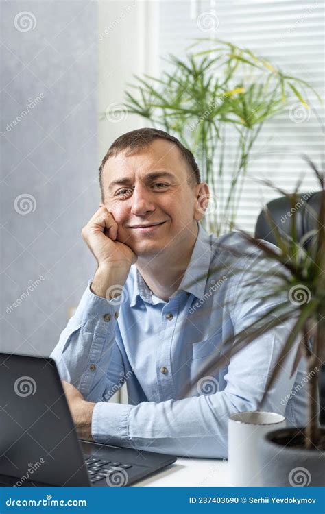 Cheerful Good Natured Man At His Workplace Friendly Boss Stock Photo