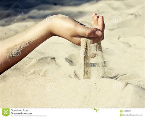 sand is pouring through his fingers stock image image of beach female 44556575