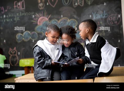 School Kids Reading In The Classroom Stock Photo Alamy