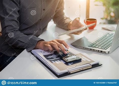 Businessman Working On Desk Office With Using A Calculator To Calculate