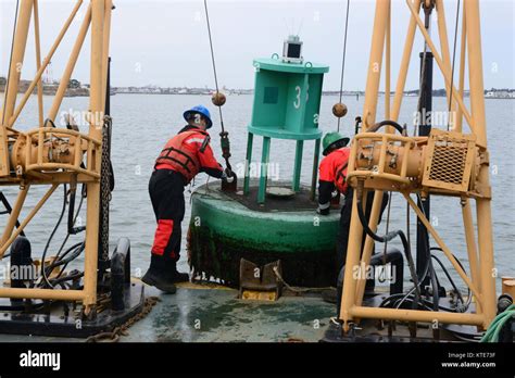 Coast Guard Aids To Navigation Team Crewmembers Work To Set A Buoy In