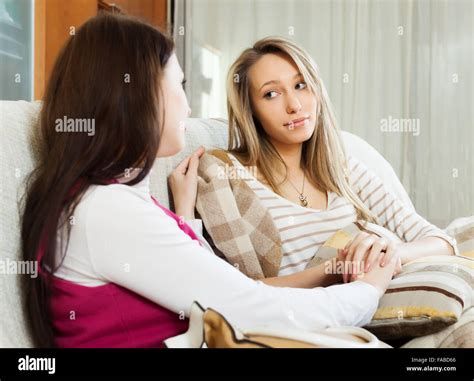 Woman Comforting Crying Friend At Sofa In Home Stock Photo Alamy