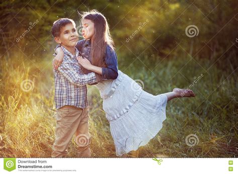 Beautiful Little Girl Kissing A Boy In The Park Stock