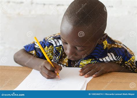 Black African Boy At School Taking Notes During Class Stock Photography