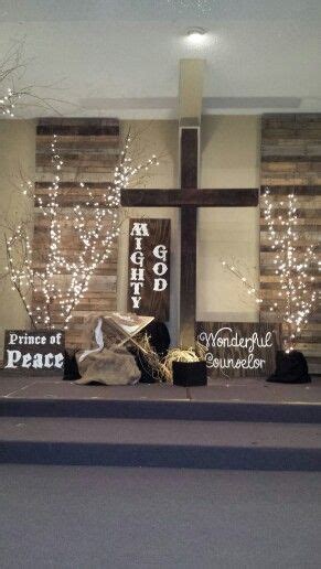 a window display with christmas decorations in front of it and a cross