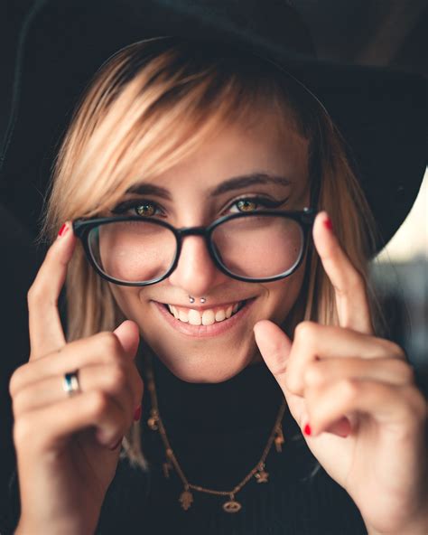 a woman wearing black framed eyeglasses and a hat pixeor large collection of inspirational