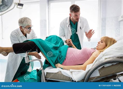 In The Hospital Woman In Labor Pushes To Give Birth Obstetricians Assisting Stock Image Image