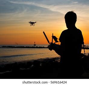 Man Operating Flying Drone Quadrocopter Sunset Stock Photo 569616424