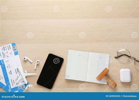 Flat Lay Composition With Passport Stamp And Flight Tickets On Wooden Table Space For Text