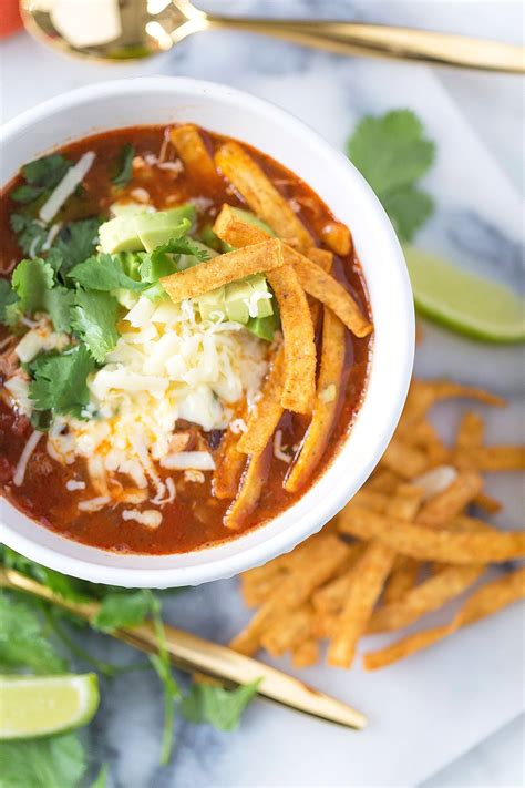 The corn tortillas help the soup to thicken a bit and also act as noodles! Crock Pot Chicken Tortilla Soup | Pizzazzerie