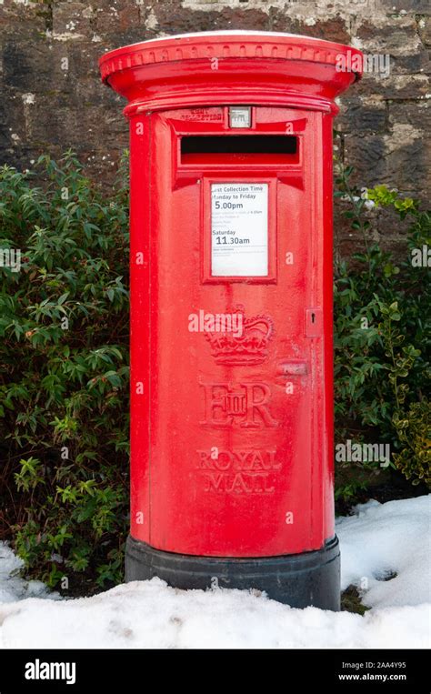 A Traditional Red British Post Box In A Snowy Rural Setting An Old