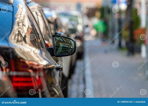 Rows Of Cars Parked Along The Roadside In Crowded City Stock Image