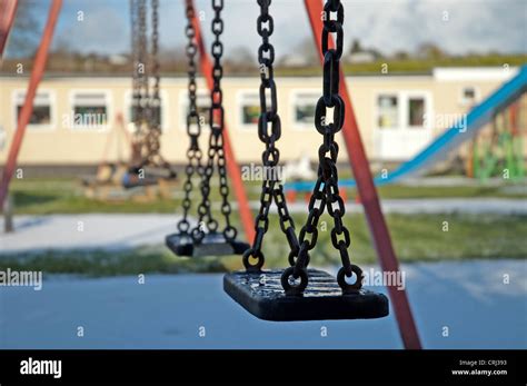 Empty Swings In A Childrens Playground Stock Photo Alamy