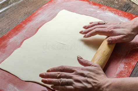 The Chef Rolls Out The Dough With A Rolling Pin Stock Photo Image Of