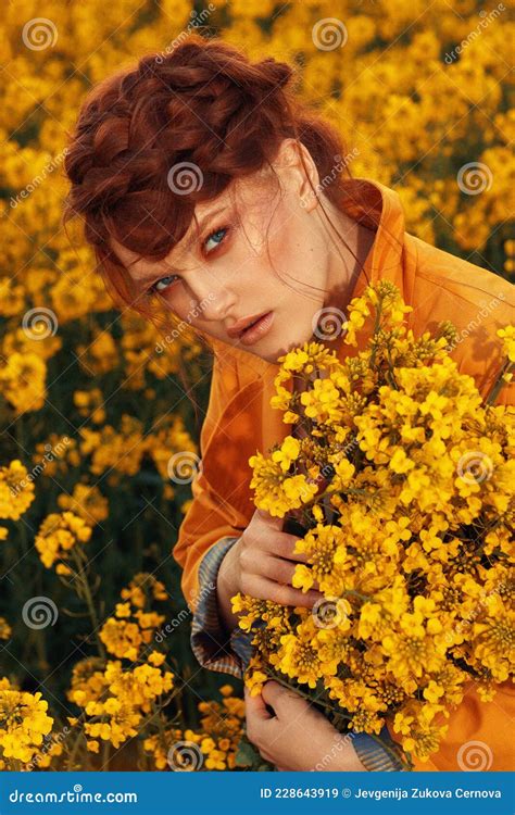 Young Fashion Model Portrait With Ginger Hair And Blue Eyes In Yellow