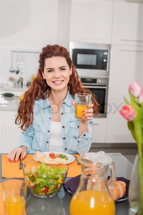 Smiling Girl Sitting At Table With Meal Stock Image Colourbox