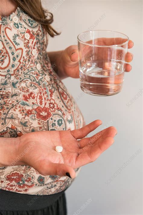 Pregnant Woman Taking Medication Stock Image C Science Photo Library