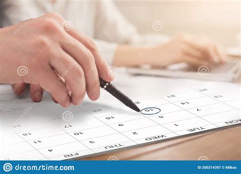 People In Office Planning Business Schedule Marking Date In Calendar